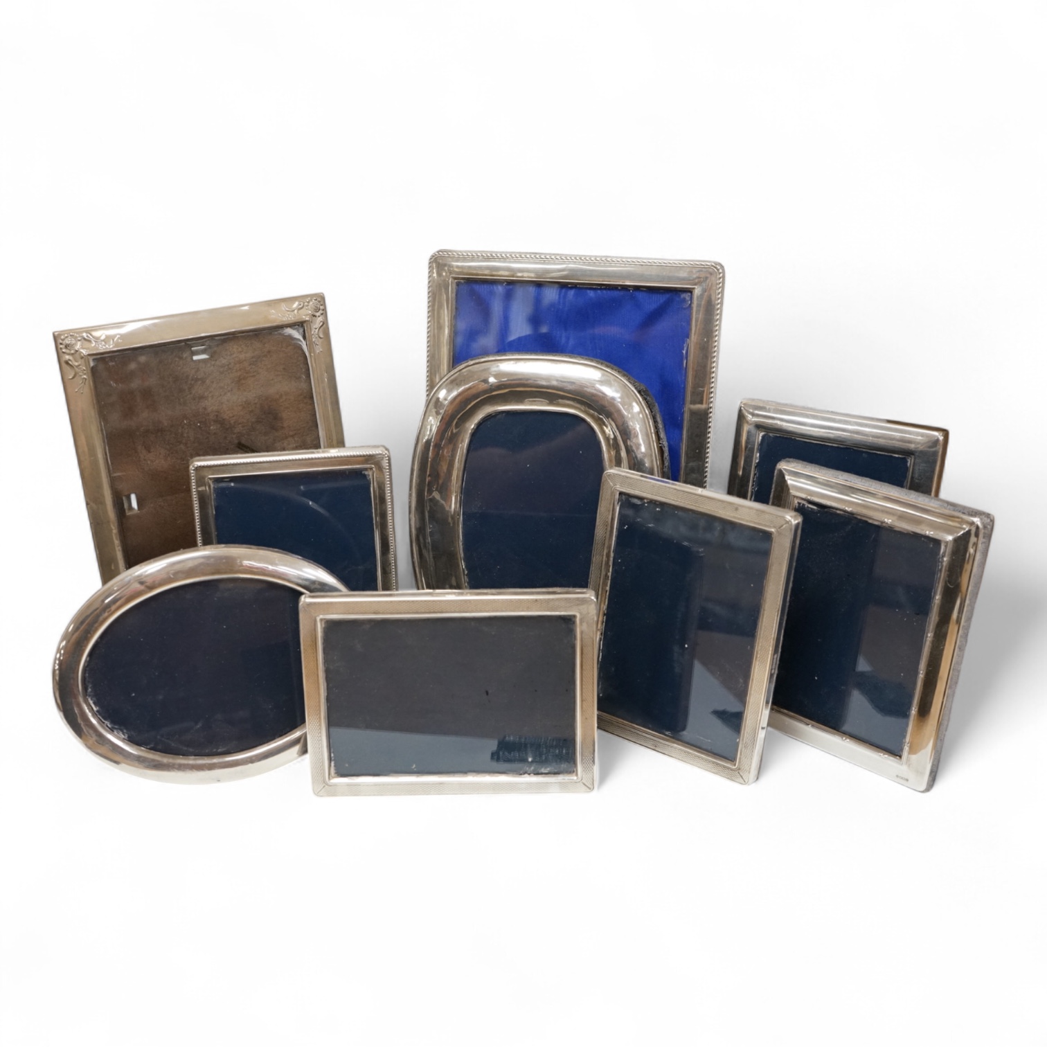 A pair of modern engine turned silver mounted rectangular photograph frames, by Carr's of Sheffield, Sheffield, 1992/3, 14.8cm, together with seven other modern silver mounted photograph frames, largest 23.1cm.